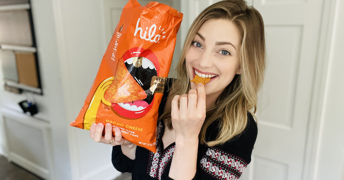 woman biting chip holding bag of hilo chips