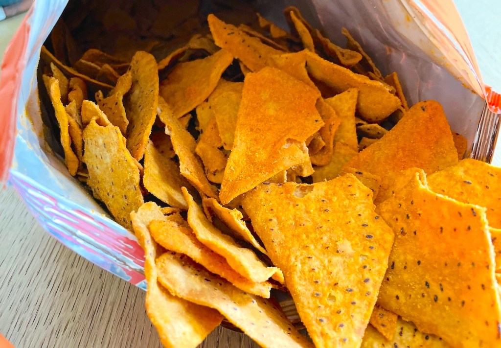 close up of orange chips spilling out of bag