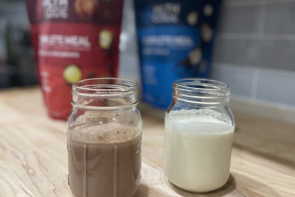 chocolate and vanilla keto shakes on counter with bags in background