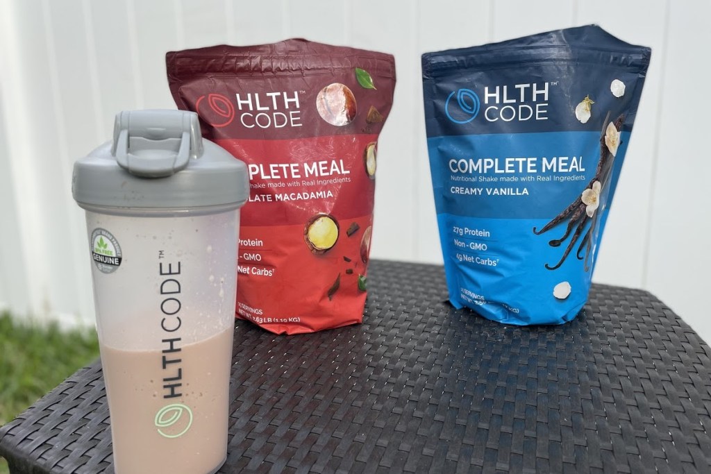 hlth code blender bottle in front of meal replacement powder bags