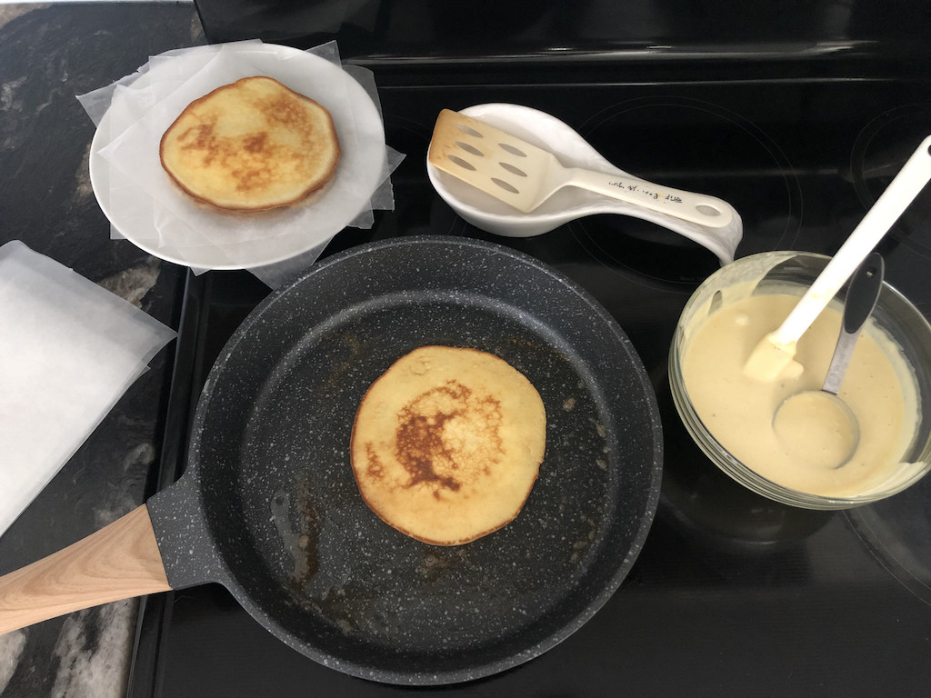 keto crepes cooking in skillet