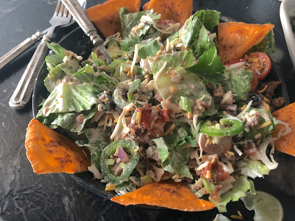 taco salad with toppings and cheese chips 