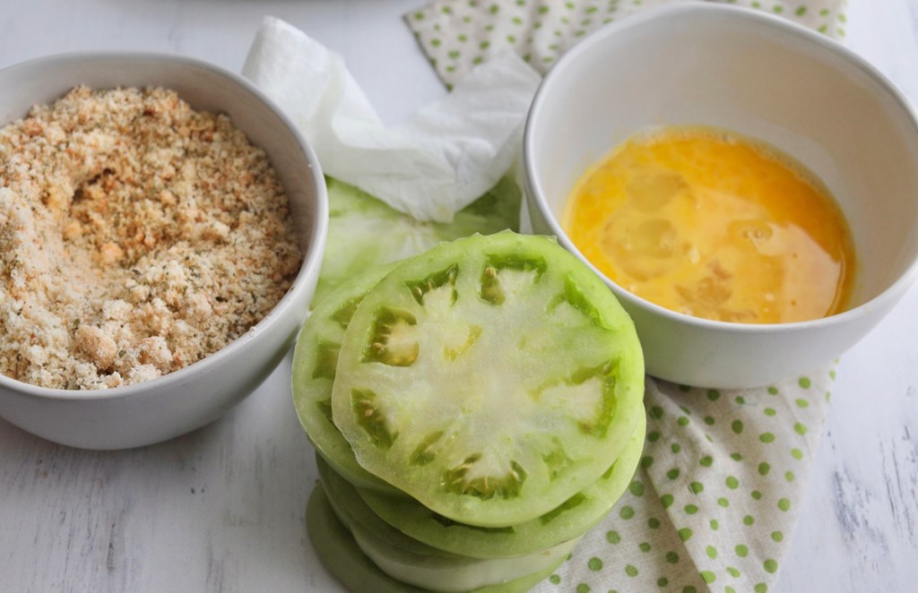 tomatoes and breading ingredients on table