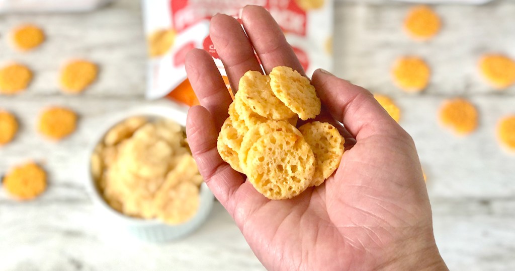 hand holding whisps cheese crisps
