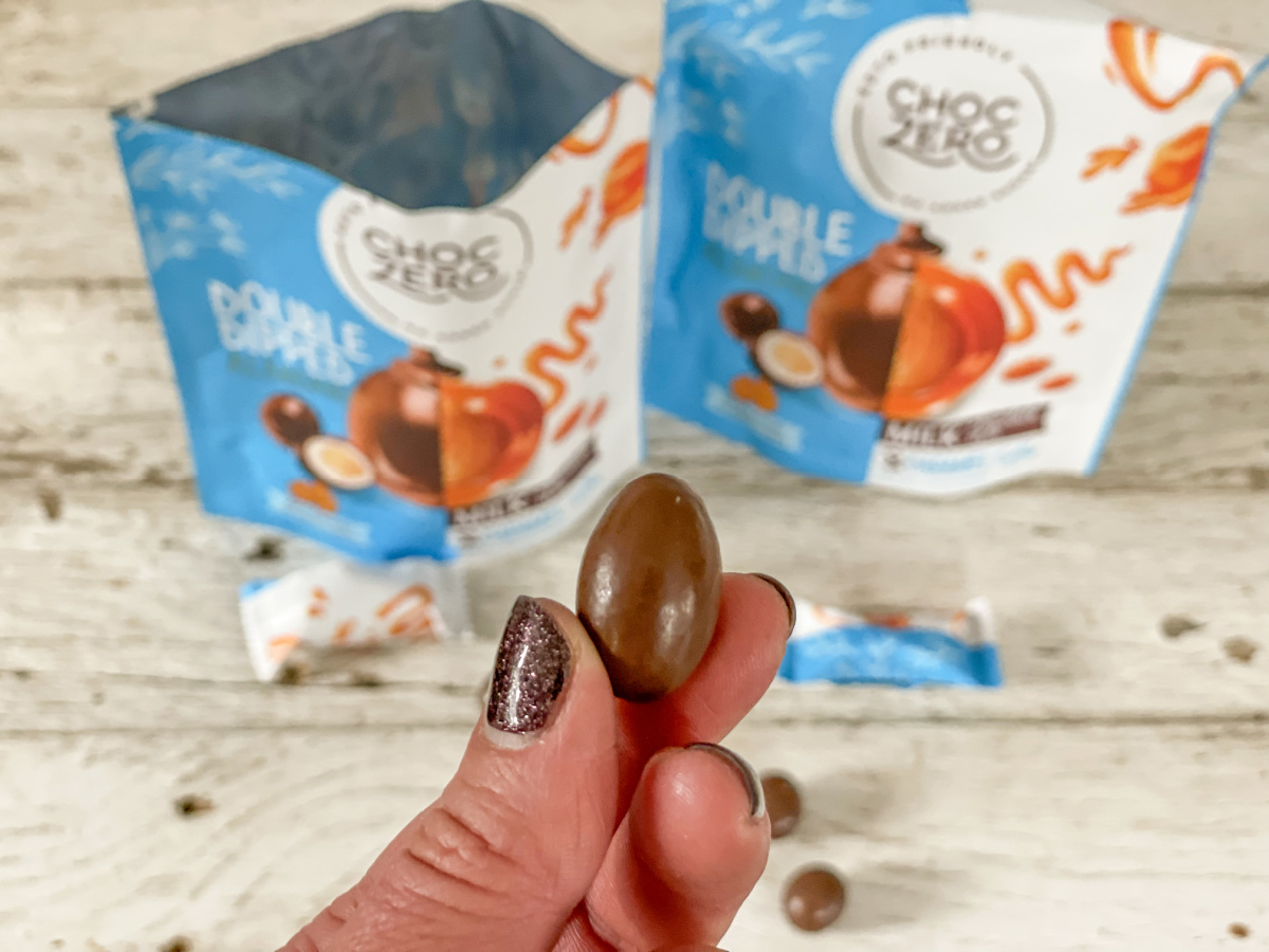 hand holding double dipped almonds