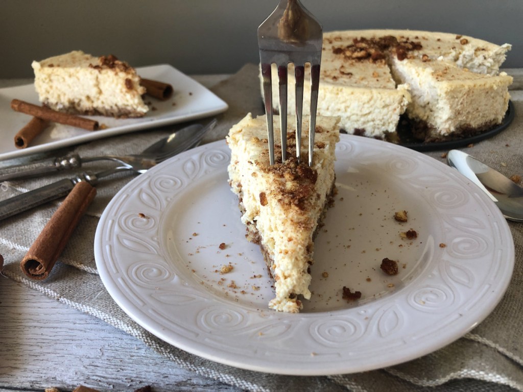 fork in a slice of keto churro cheesecake