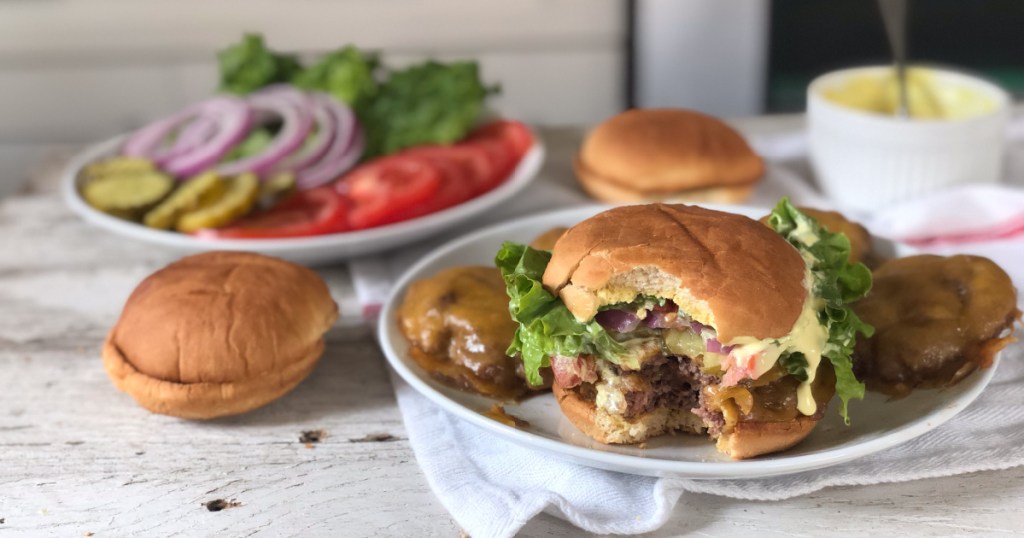 smash burger recipe on a plate with a bite out of it