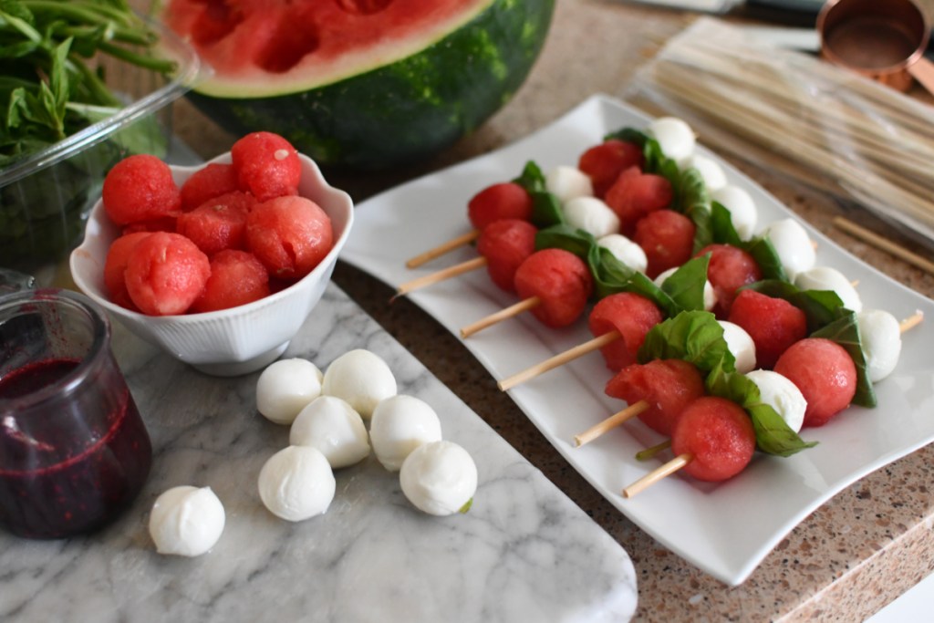 preparing Watermelon caprese skewers that are keto-friendly