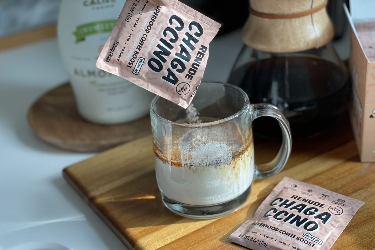 pouring a Chagaccino packet into a cup of milk