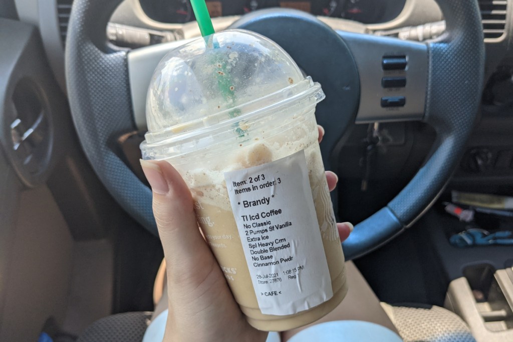 Hand holding keto Starbucks cinnamon dolce frappuccino