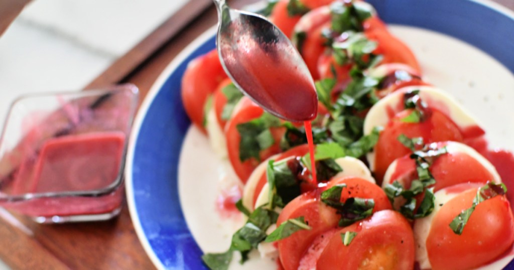 drizzle of dressing on caprese salad