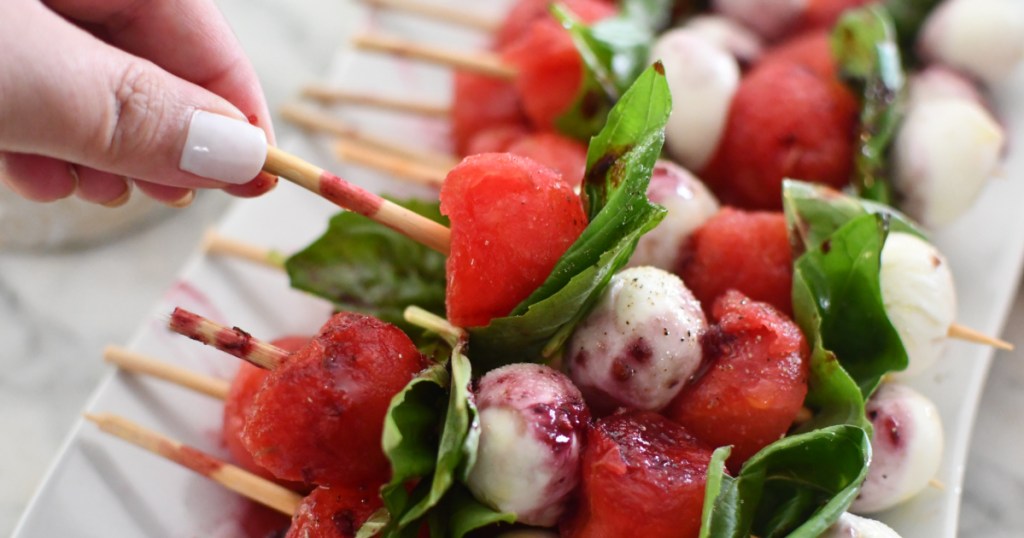 holding a keto watermelon skewer