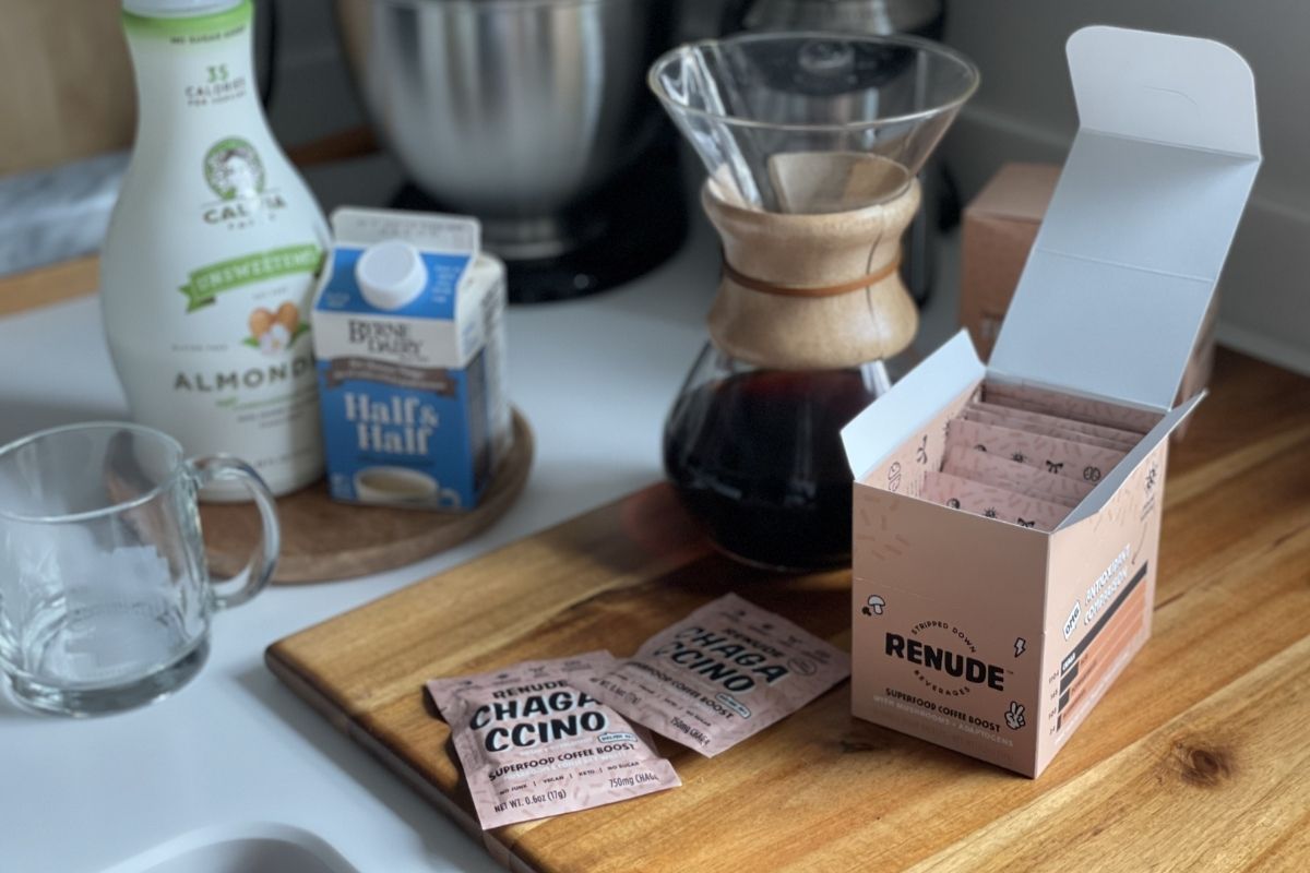 Renude Chagaccino packets, Chemex coffee maker, almond milk and mug on counter