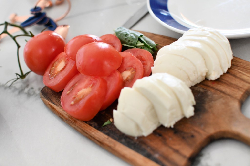 slicing tomatoes and fresh mozzarella 