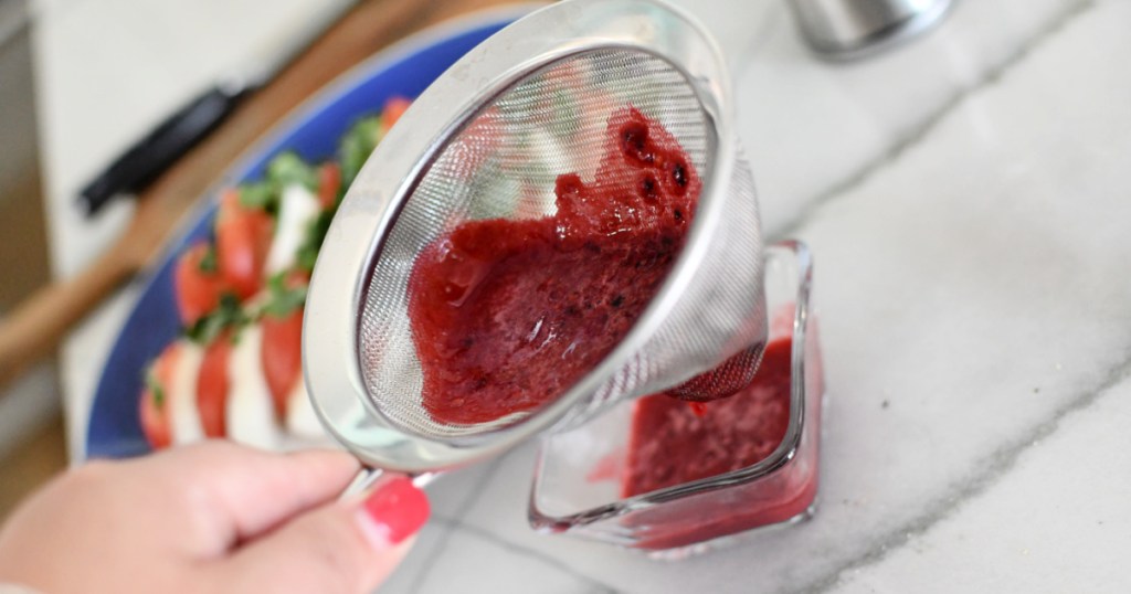 straining blackberry salad dressing