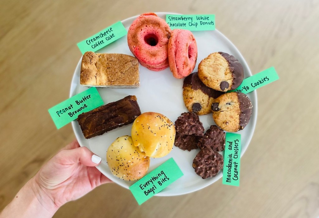 hand holding plate full of keto bakery goods