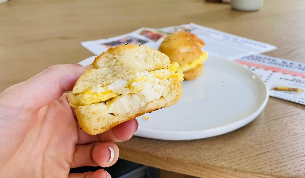 hand holding everything bagel egg sandwich