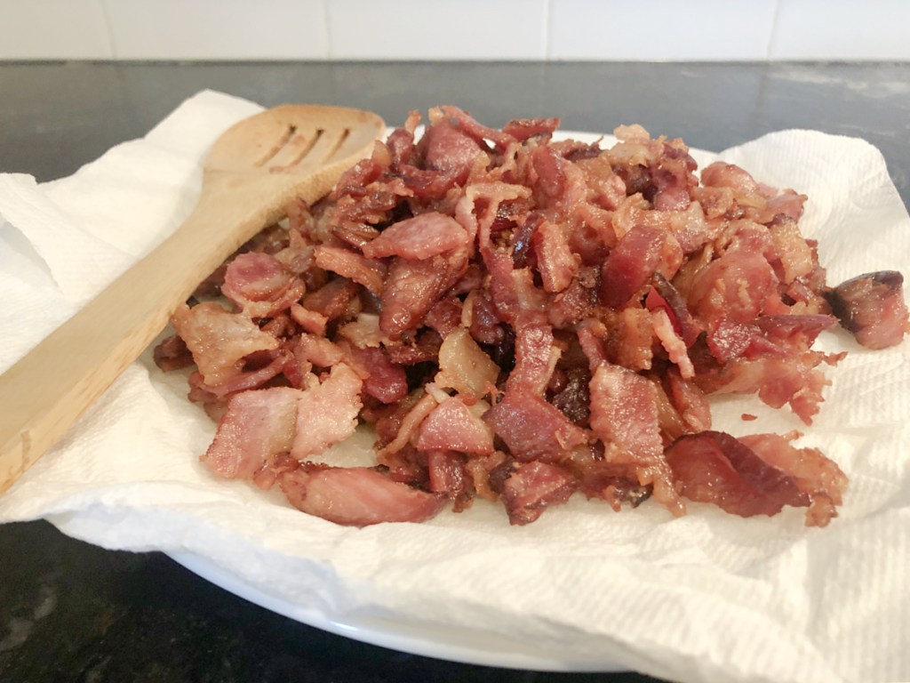bacon ends and pieces cooked on a paper towel