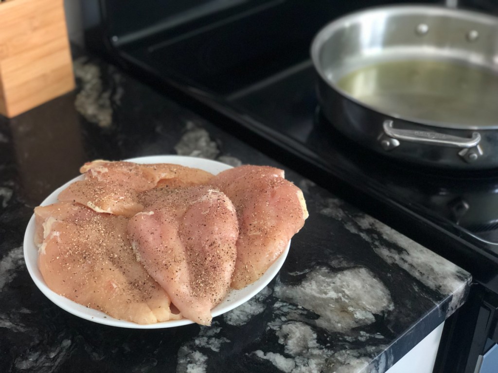 raw chicken breasts on plate