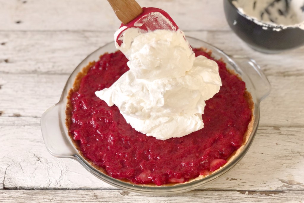 adding whipped cream to keto strawberry pie