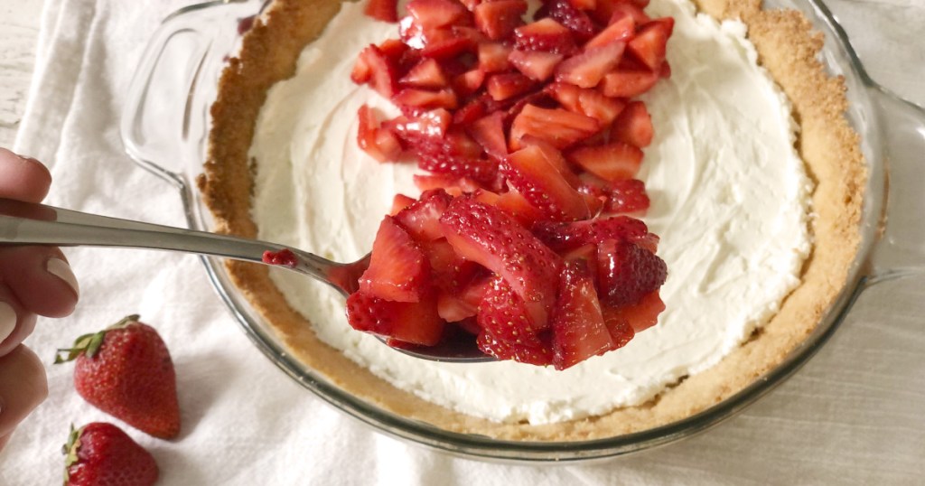 spoonful of strawberries in front of sugar free keto strawberry pie