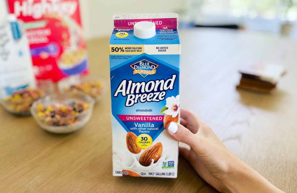 hand holding carton of unsweetened almond milk