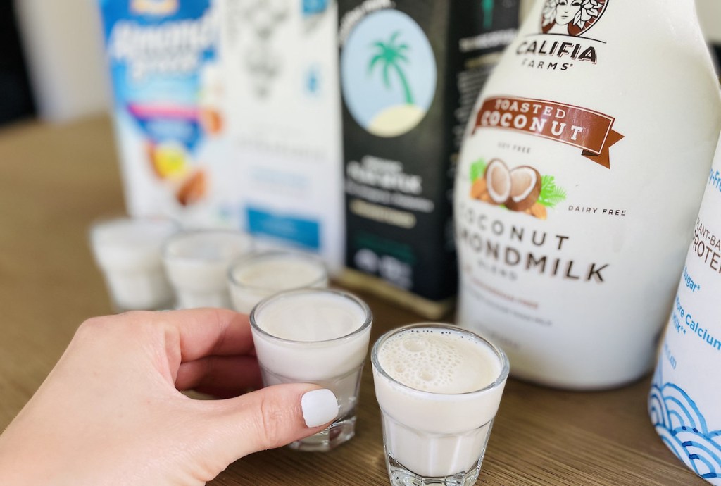 close up of hand holding shot glass of dairy free keto milk