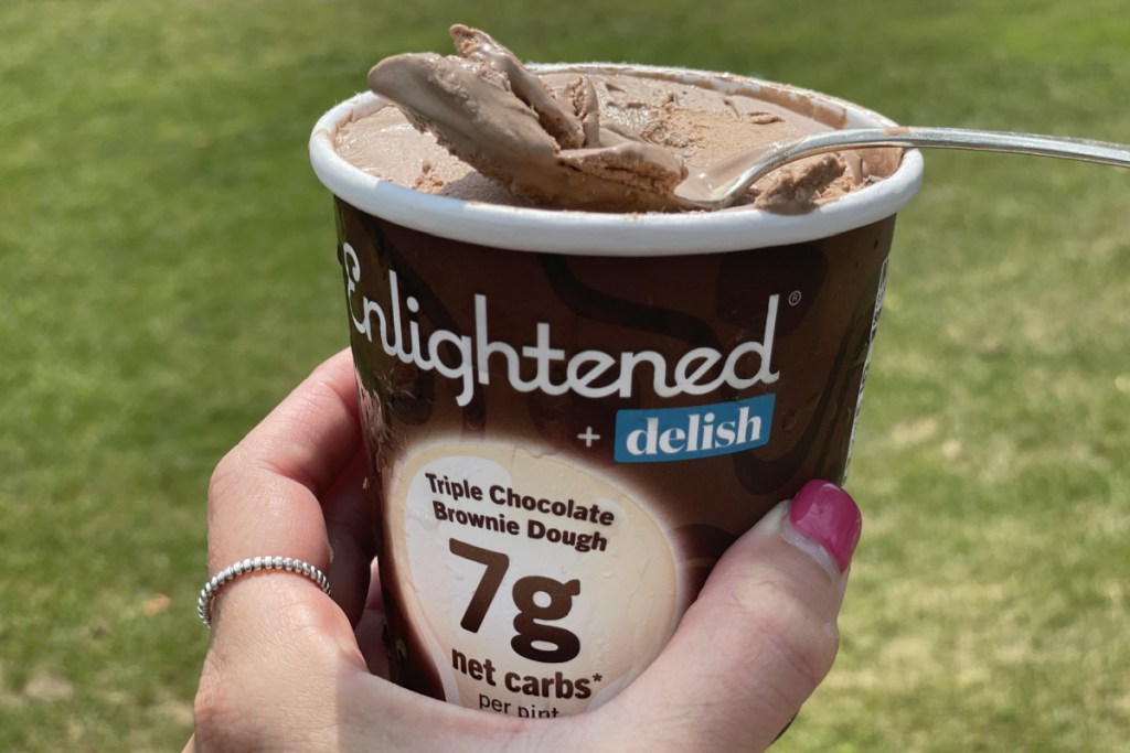 holding a pint of Enlightened triple chocolate brownie dough ice cream