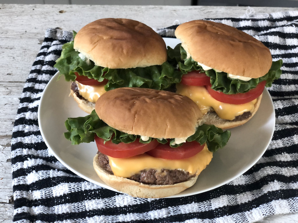 keto cheeseburgers on plate with all the fixings 