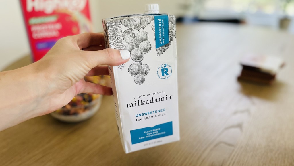 hand holding carton of milkadamia milk