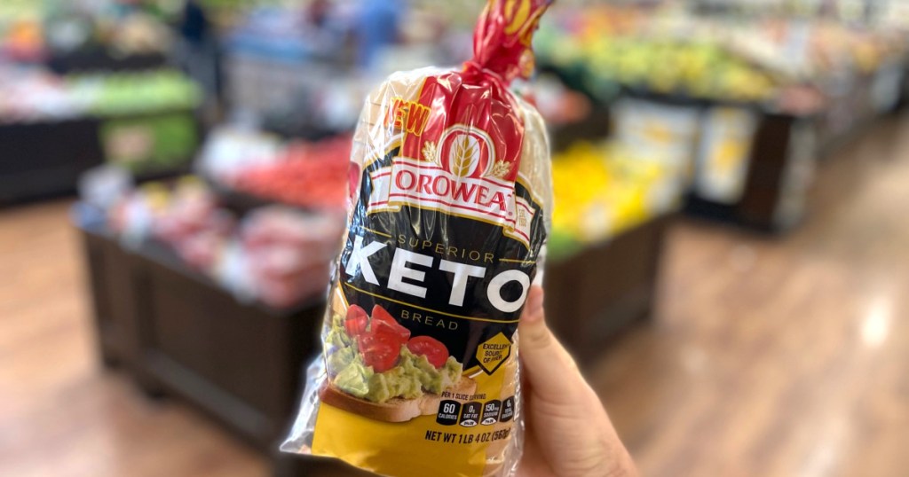 holding loaf of Oroweat keto bread in the store 