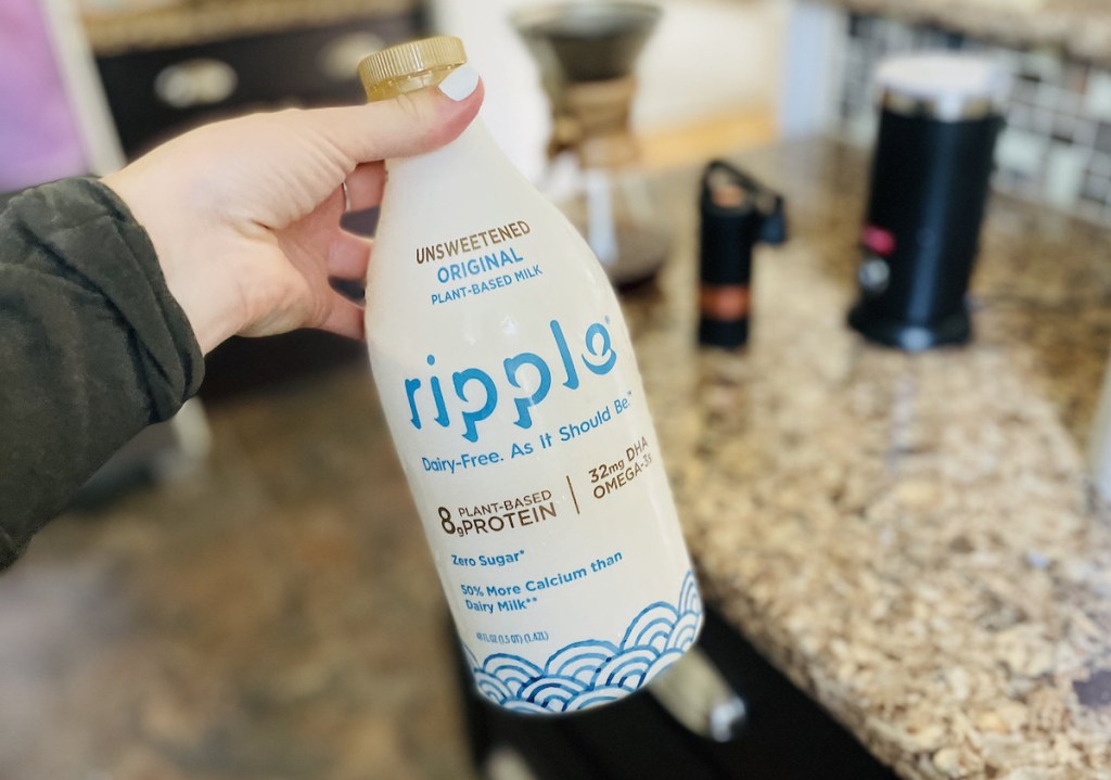 hand holding bottle of ripple plant based keto dairy free milk