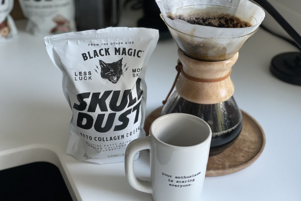 coffee maker next to cup and bag of Skull Dust creamer