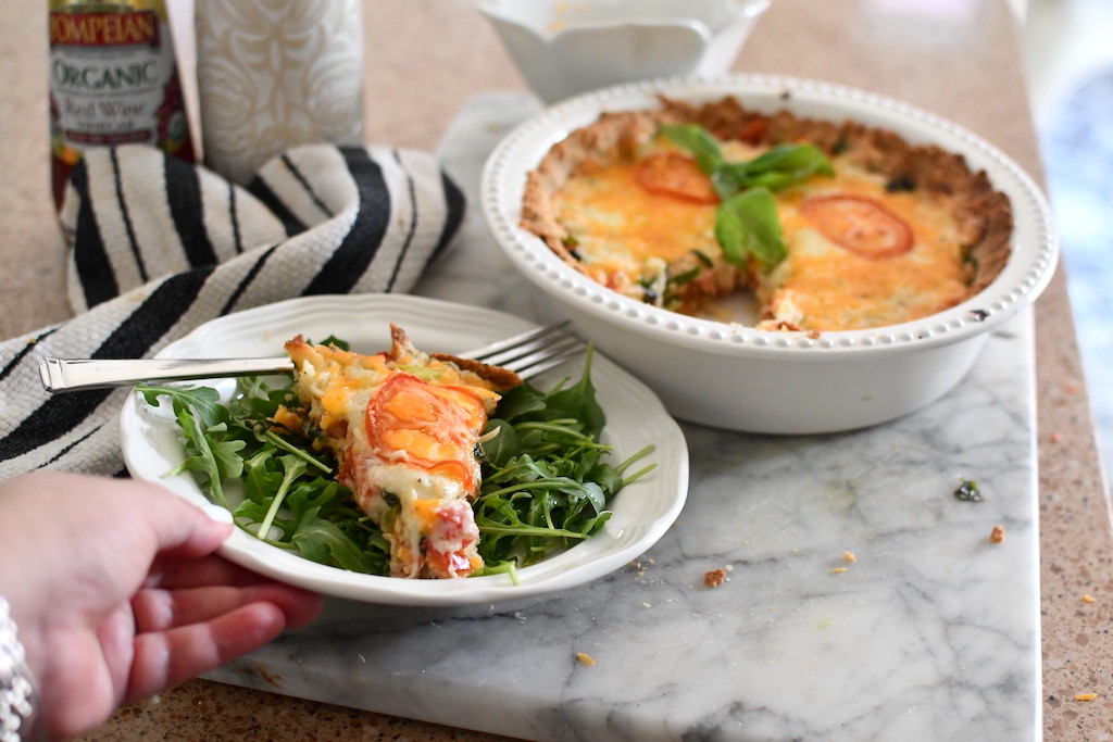 serving keto tomato pie with salad