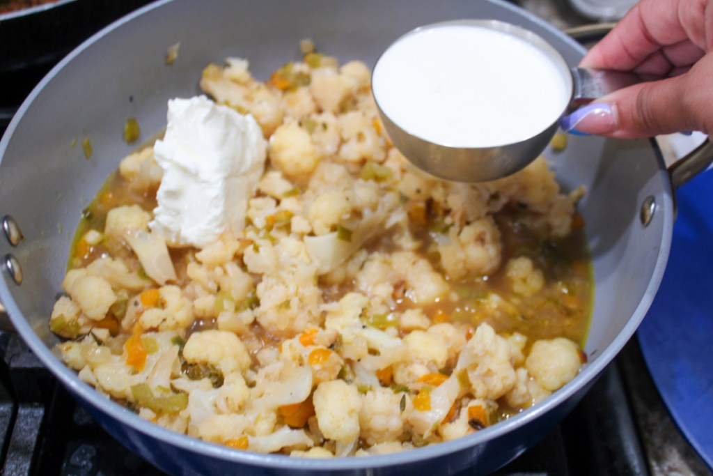 Adding Cream to creamy cauliflower soup
