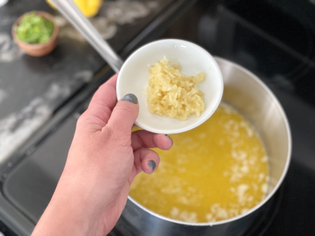 adding garlic to cowboy butter