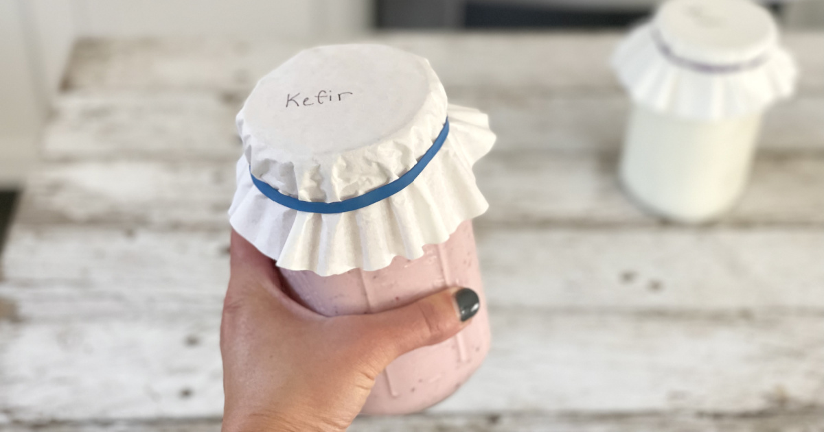 holding jar of flavored kefir