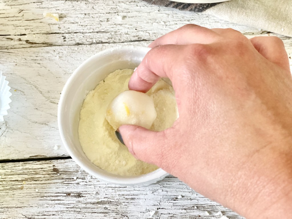 rolling keto lemon fat bomb in coating