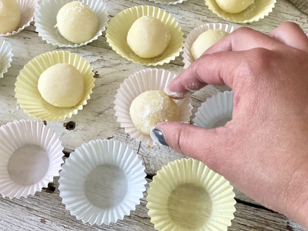 placing keto lemon fat bombs in cupcake liner