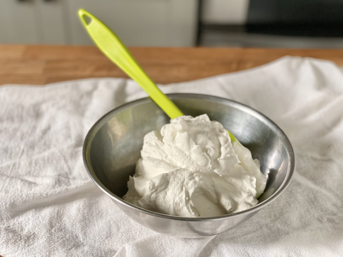 bowl of keto whipped cream with spatula