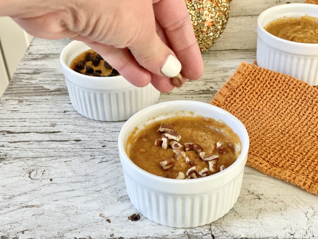 adding pecans to Keto Pumpkin Mug Cake