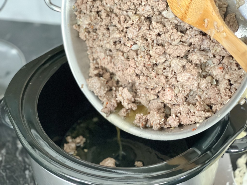 pouring ground meat into slow cooker for Low Carb Cabbage Roll Soup