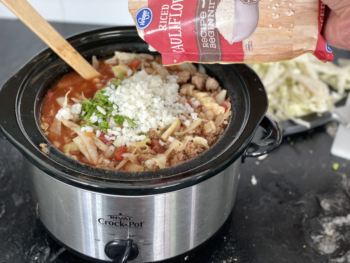 adding cauliflower rice to Low Carb Cabbage Roll Soup, one of our favorite keto Crockpot recipes