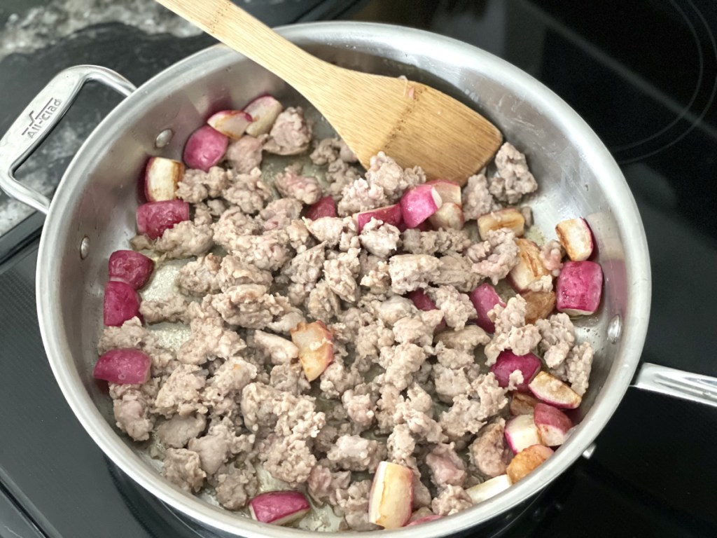 radishes and sausage in a skillet for sausage hash