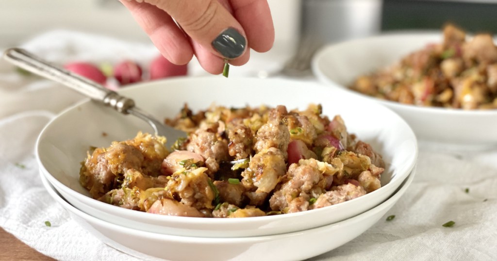 adding chives to sausage hash