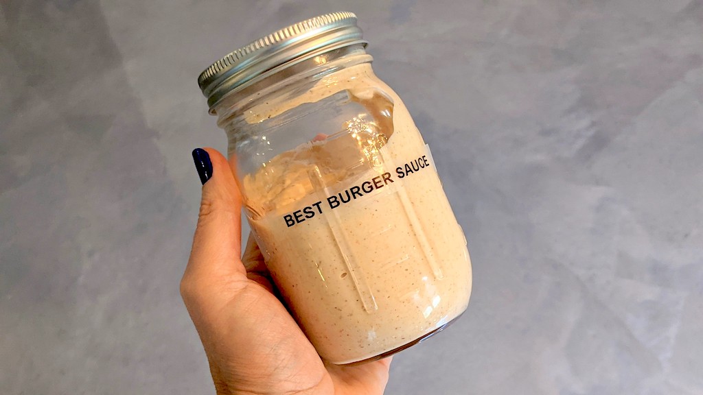 holding jar of keto burger sauce 