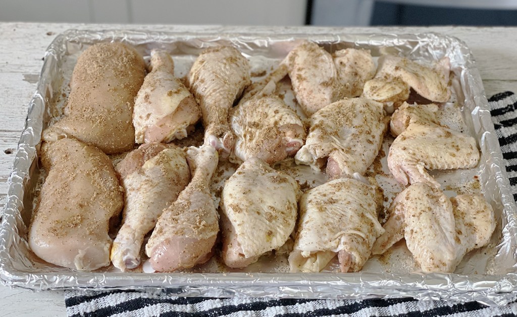 seasoned chicken pieces on sheet pan