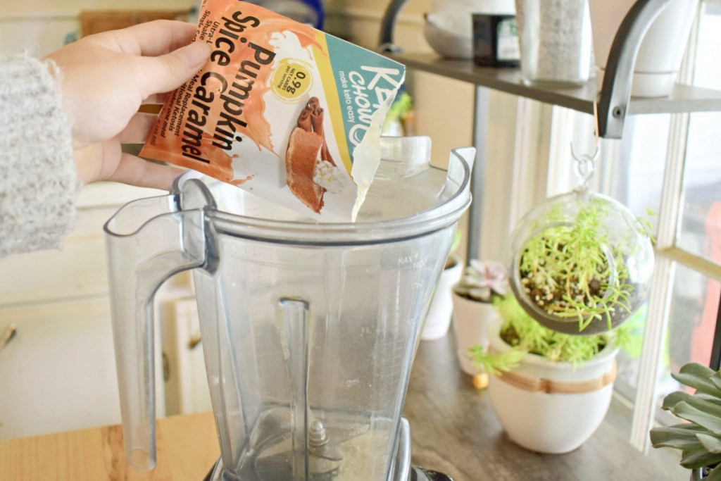 pouring packet of Pumpkin Spice Caramel Keto Chow into blender