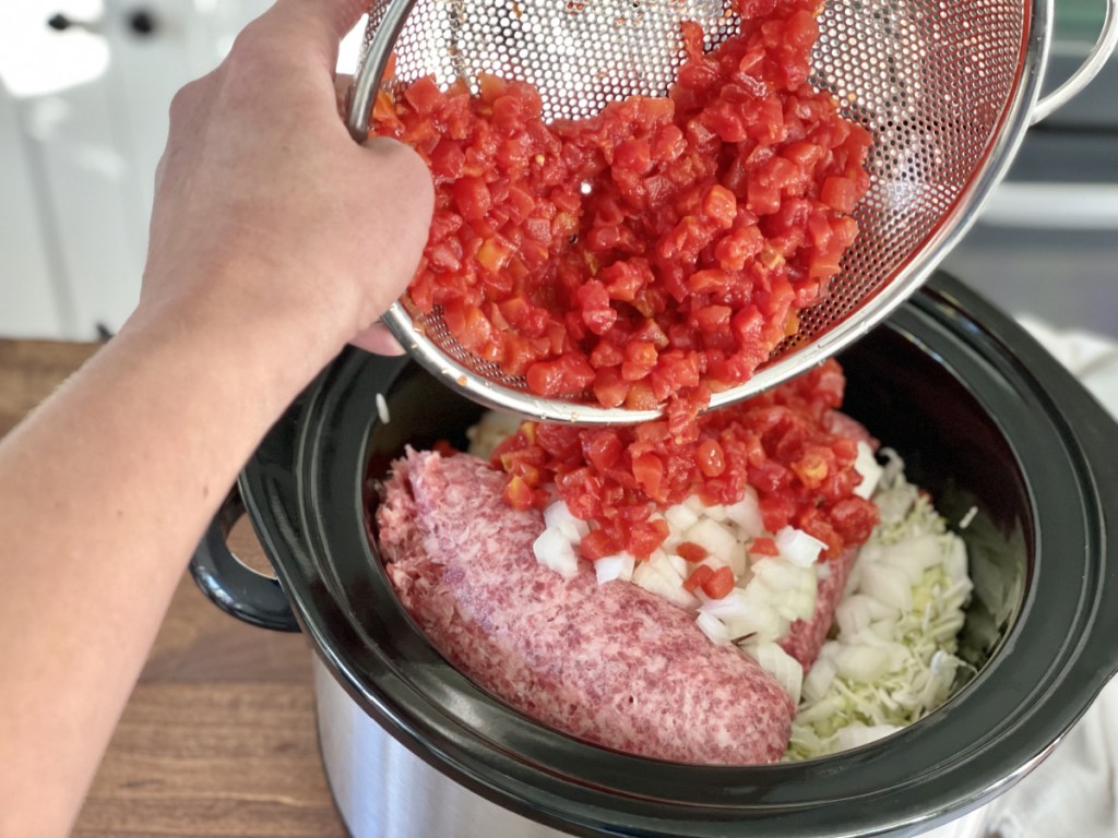 adding tomatoes to slow cooker for cabbage roll casserole 