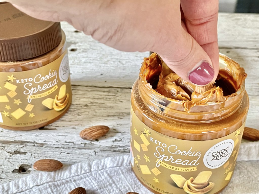 dipping an almond in ChocZero Keto Cookie Spread